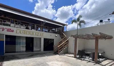 a building with a sign that reads villa laslezas at Villa las Terrazas in Cabayona