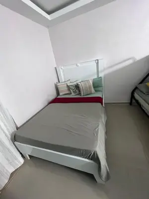 a small bedroom with a bed in a white room at Villa las Terrazas in Cabayona