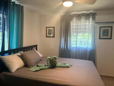 a stuffed turtle sitting on a bed in a bedroom at Mi casa es tu casa in Santo Domingo