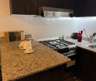 a kitchen with a stove and a counter top at Mi casa es tu casa in Santo Domingo