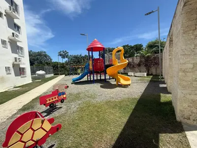 a playground with a slide and play equipment in a yard at Mi casa es tu casa in Santo Domingo
