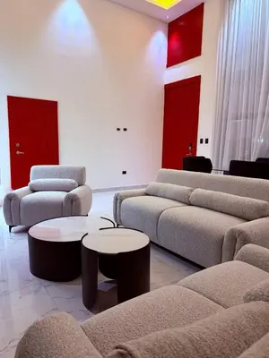 a living room with couches and tables and red accents at Tropical Escape Villa in Puerto Plata
