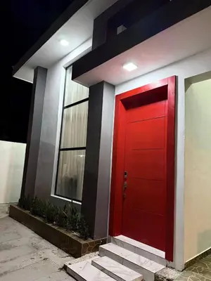 a red door on the side of a building at Tropical Escape Villa in Puerto Plata