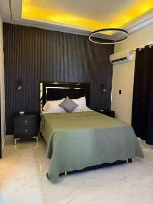 a bedroom with a large bed with a green blanket at Tropical Escape Villa in Puerto Plata