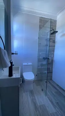 a bathroom with a toilet and a glass shower at Mar, Sol y Arena in Paraíso