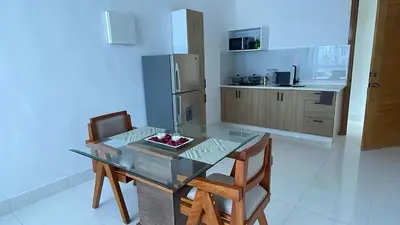 a kitchen with a glass table and two chairs at Mar, Sol y Arena in Paraíso