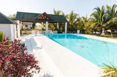 a swimming pool with a gazebo next to a house at LAS PALMAS 2 VILLA 20 personnes pool in Palmar de Ocoa