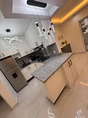 a kitchen with white cabinets and a granite counter top at Luxury NEW Stylish apartment Bayahibe with pool in Bayahibe