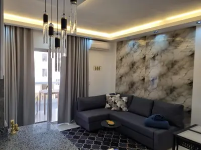 a living room with a couch and a marble wall at Luxury NEW Stylish apartment Bayahibe with pool in Bayahibe