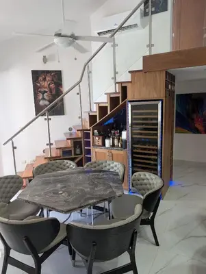 a dining room with a table and chairs and stairs at Hispanola Beach 3 Bdr Outdoor Jacuzzi in Sosúa