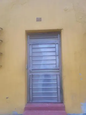 a gray garage door on the side of a building at Apartamento dos dormitorios en la zona colonial in Santo Domingo