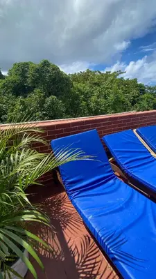 a blue couch sitting on top of a roof at A Few Steps to Malecon and Sunny Beaches in San Felipe de Puerto Plata