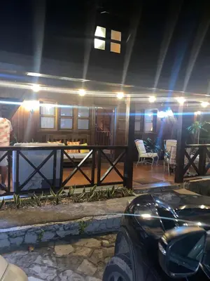 a house with a car parked in front of it at Villa Flor Rubi in Jarabacoa