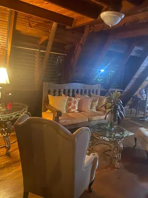a living room with a couch and a table at Villa Flor Rubi in Jarabacoa