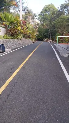 an empty road with a yellow line in the middle at Villa Flor Rubi in Jarabacoa