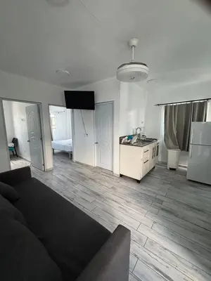 a living room with a couch and a kitchen at Calle Roma in Bayahibe