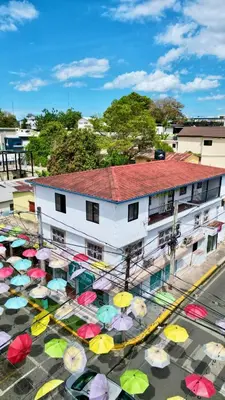 a building with a bunch of umbrellas on the street at Brisas de Jarabacoa in Jarabacoa