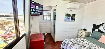 a small room with a bed and a window at Brisas de Jarabacoa in Jarabacoa