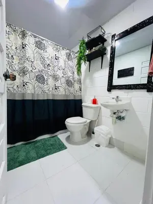 a bathroom with a toilet and a sink at Brisas de Jarabacoa in Jarabacoa
