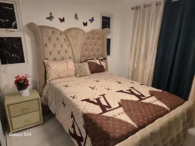 a bedroom with a bed with a quilt on it at Peaceful Cottage in Santiago de los Caballeros