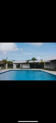 a large swimming pool in front of a building at Costa bávaro garden in Punta Cana