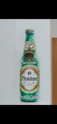 a bottle of beer sitting on a table at Costa bávaro garden in Punta Cana