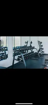 a gym with a bunch of racks of equipment at Costa bávaro garden in Punta Cana