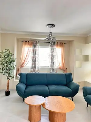 a living room with a blue couch and two tables at Vista del sol in La Viva