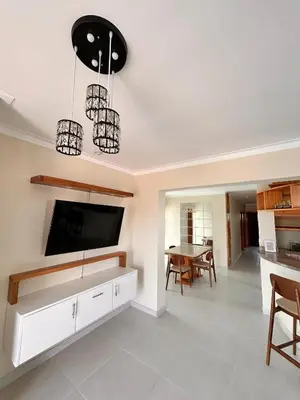 a kitchen and living room with a tv and a table at Vista del sol in La Viva