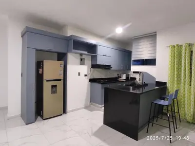 a kitchen with a refrigerator and a counter top at Apartament with Beautiful Mountain View in Puerto Plata