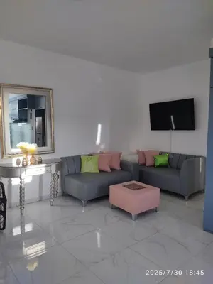 a living room with a couch and a tv at Apartament with Beautiful Mountain View in Puerto Plata