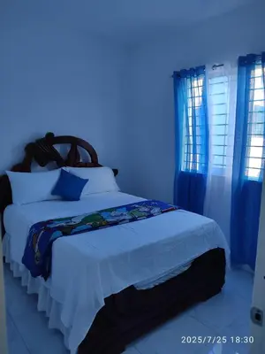 a bedroom with a bed with a blue light at Apartament with Beautiful Mountain View in Puerto Plata