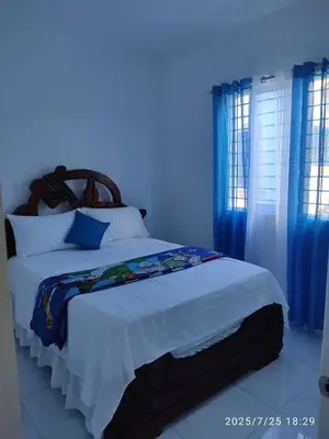 a bedroom with a bed with a blue light at Apartament with Beautiful Mountain View in Puerto Plata