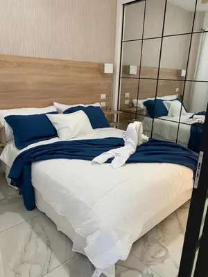 a bedroom with a large bed with blue and white pillows at Beach Golf penthouse Arena Gorda Beach P C in Punta Cana
