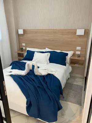 a large bed with blue and white sheets and pillows at Beach Golf penthouse Arena Gorda Beach P C in Punta Cana