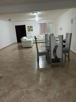 a living room with a table and chairs and a couch at Villas Maniscalco in Camú