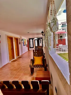 a living room with chairs and a wooden floor at Noe hotel in Punta Cana