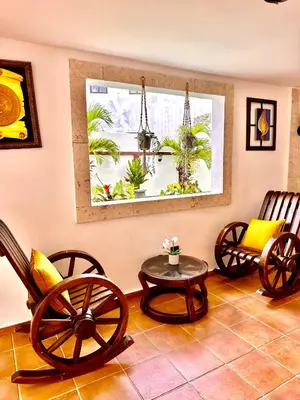 a room with chairs and a table and a window at Noe hotel in Punta Cana