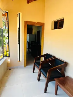 a living room with a chair and a table at Brisas de Valle in Jarabacoa