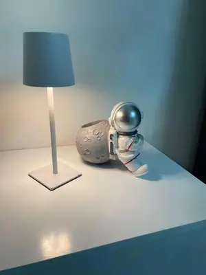 a robot sitting on a table next to a lamp at Modern Rooftop Penthouse Private Large Jacuzzi for 12 in Santiago de los Caballeros