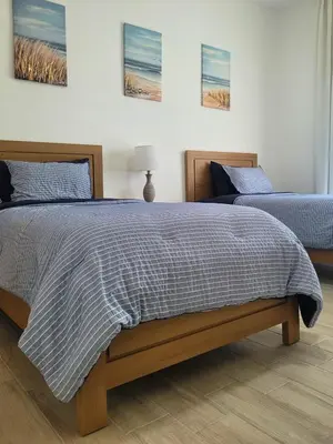 a bedroom with a bed with a striped blanket at Ona Residences Punta Cana in Punta Cana