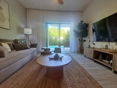 a living room with a couch and a coffee table at Ona Residences Punta Cana in Punta Cana