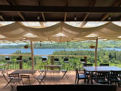 a patio with tables and chairs and a view of a lake at Villas del lago resort in Colorado