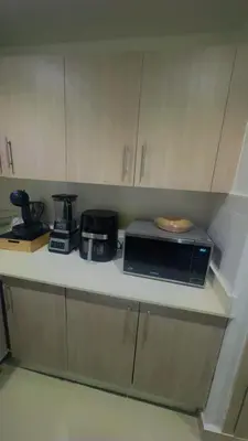 a kitchen counter with a microwave and appliances on it at Elsa in Jacagua