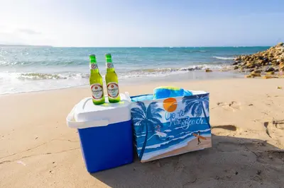 two bottles of beer in a trash can on the beach at View to paradise, One bedroom apartment in Puerto Plata