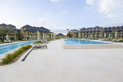 a swimming pool at a resort with condos at View to paradise, One bedroom apartment in Puerto Plata