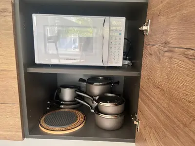a microwave and some pots and pans in a cabinet at Estrella Izha 204 in La Laguna