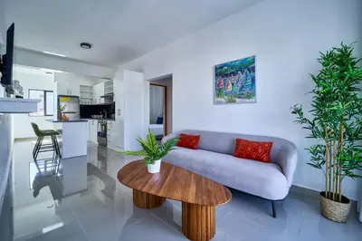 a living room with a couch and a table at Cozy Nest in La Romana