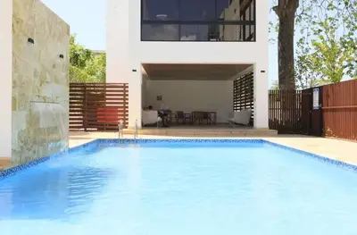a swimming pool in front of a house at Luxury Beachside Escape 3BR 2BA with Pool & Ocean Views in San Felipe de Puerto Plata