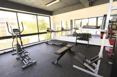 a gym with several treadmills and machines in a room at Luxury Beachside Escape 3BR 2BA with Pool & Ocean Views in San Felipe de Puerto Plata